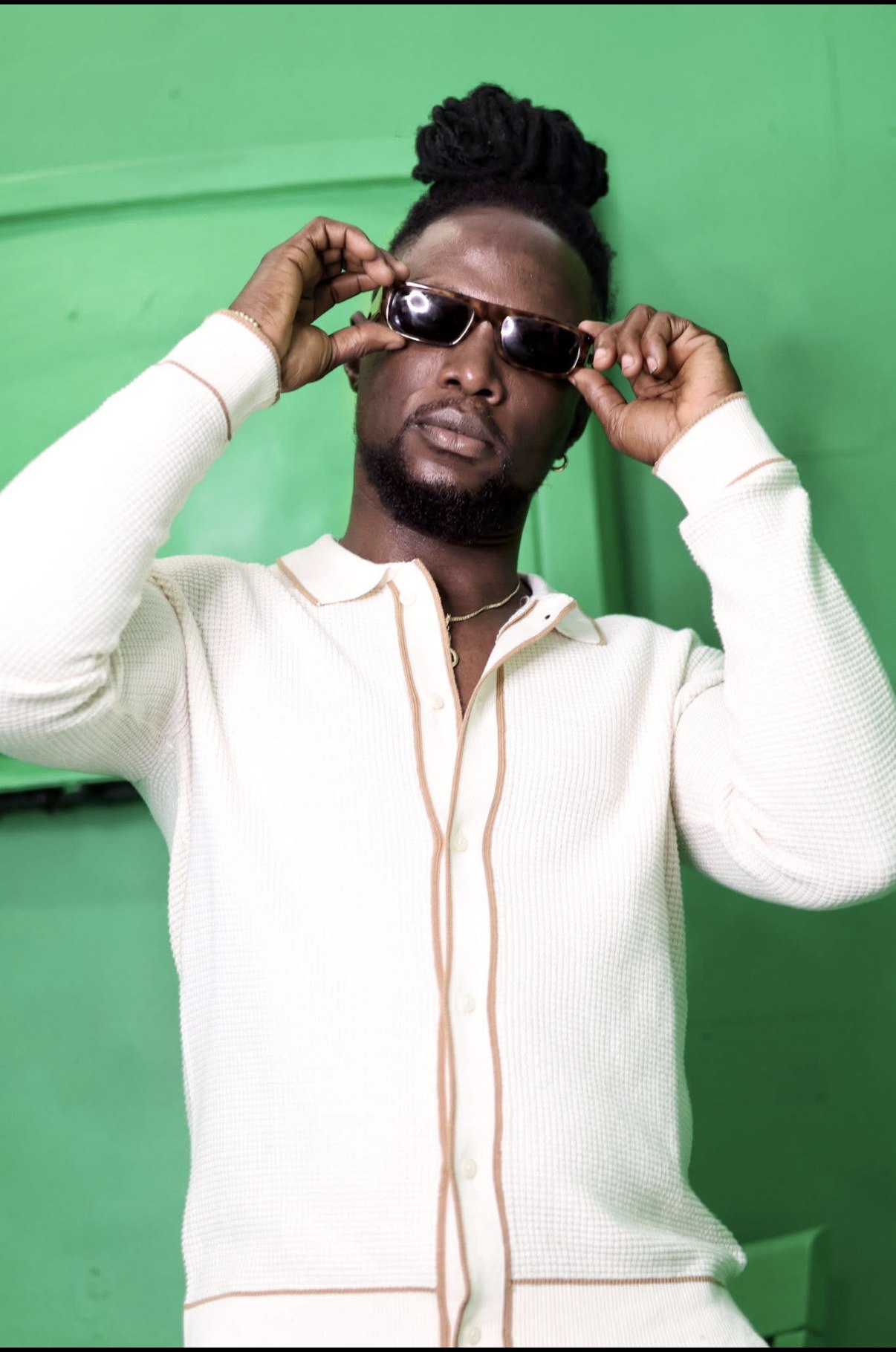 Male model photographed against a green background